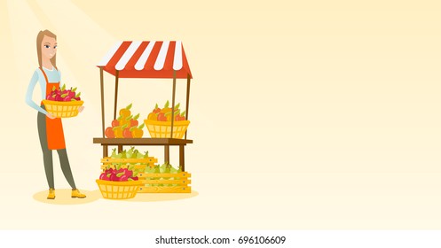 Young caucasian greengrocer holding box full of apples. Smiling female greengrocer standing in front of grocery stall with vegetables and fruits. Vector flat design illustration. Horizontal layout.