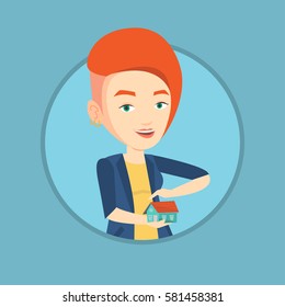 Young caucasian insurance agent holding house model. Insurance agent protecting model of the house. Property insurance concept. Vector flat design illustration in the circle isolated on background.