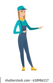 Young caucasian mechanic pointing to the side. Full length of mechanic pointing finger to the side. Mechanic pointing to the right side. Vector flat design illustration isolated on white background.