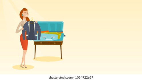Young caucasian white woman packing her clothes in an opened suitcase. Woman putting a jacket into a suitcase. Cheerful woman preparing for vacation. Vector cartoon illustration. Horizontal layout.