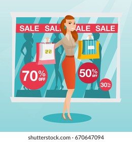 Young caucasian woman showing shopping bags in front of shop window with sale sign. Woman standing on the background of shop window with text sale. Vector flat design illustration. Square layout.