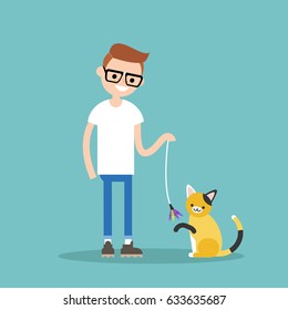 Young character playing with a cat / flat editable vector illustration, clip art