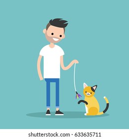Young character playing with a cat / flat editable vector illustration, clip art