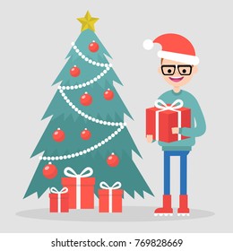 Young character standing near by a christmas tree and holding a gift box. Winter holidays. Flat editable vector illustration, clip art