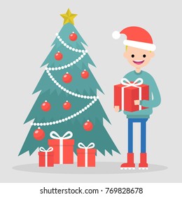 Young character standing near by a christmas tree and holding a gift box. Winter holidays. Flat editable vector illustration, clip art
