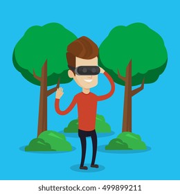 Young cheerful caucasian gamer wearing virtual reality headset in the park. Happy man using virtual reality glasses and playing videogame in the park. Vector flat design illustration. Square layout.