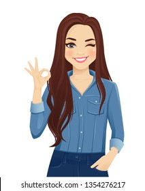 Young cheerful woman with long hair in casual denim shirt gesturing ok sign isolated vector illustration