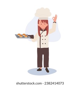 Young Chef Showing OK Sign. Happy Chef Doing OK Hand Sign and holding fresh baked bun on tray in other hand