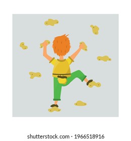 A young climber climbs the track on the climbing wall.