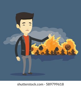 Joven preocupado hombre asiático apuntando al bosque en llamas. Hombre frustrado en el fondo de un gran incendio forestal. Concepto de destrucción ambiental. Ilustración de diseño plano vectorial. Diseño cuadrado.