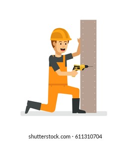 A young construction guy drilling the wall