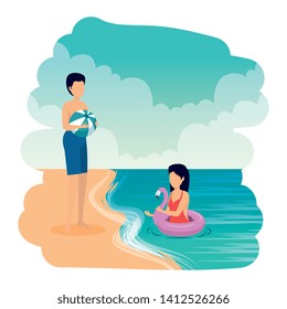 young couple with balloon and float on the beach