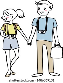 Young couple with camera. Cute tourist couple with cameras walking hand in hand. Cheerful man and woman with cameras holding hands and enjoying sightseeing. Young tourist women walking hand in hand.