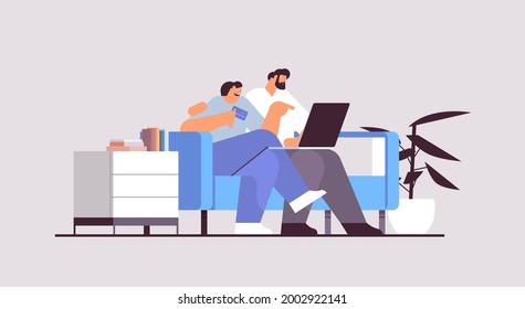 young couple with credit card using laptop online shopping concept man woman ordering goods together