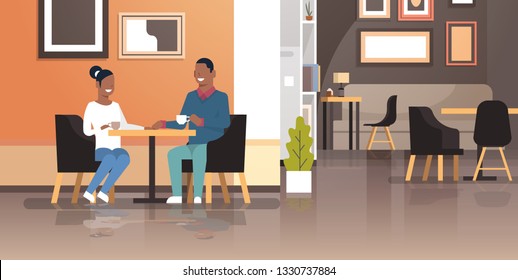 young couple drinking coffee together sitting cafe table african american man woman romantic love dating concept modern restaurant interior flat horizontal