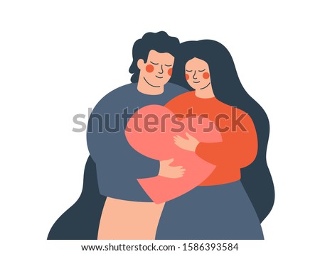 A young couple embraces each other with love and care. Happy woman and man hold a big heart together. Concept of the Valentine day and family day