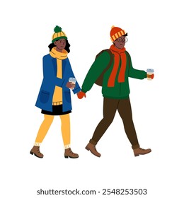 Young couple enjoying a winter stroll while holding hands and sipping warm beverages