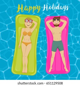 Young couple floats on inflatable mattresses in swimming pool. Top view