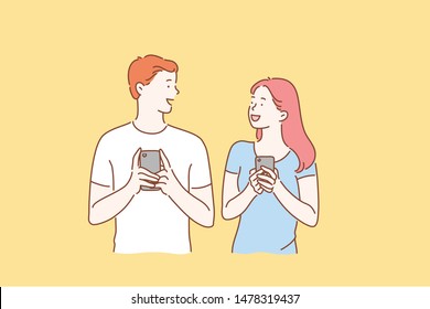 A young couple of friends blogger or school students in love watch, read, write or photograph on a mobile phone camera for a social network online. Simple flat vector.