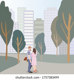 Young couple guy and girl in love with each other. A young man gives a bouquet of flowers, makes an offer to his half. Scene in the park against the backdrop of the city. life after quarantine.