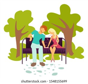 A young couple, hansome man and pretty girl, sits in a park on a bench and listens to music through headphones. Love. love for music unites