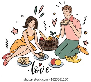 Young couple having picnic with some fruits and sandwiches
