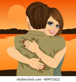 Young couple hugging on bank of river in evening at sunset