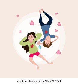 Young couple listening music on pink hearts decorated background for Happy Valentine's Day celebration.