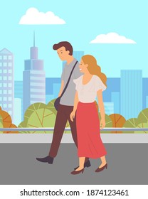 Young couple, long-haired girl and guy in brown trousers, walk in city park. Green square, skyscrapers, buildings background. Happy people hold hands and smile. Outdoor activities, open air walking