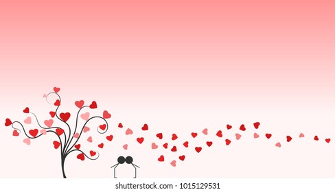 A young couple in love kissing under hearts in air, next to a tree.