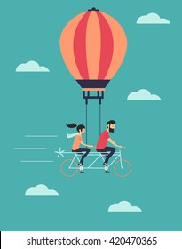 Young couple on the air balloon riding bicycle. Flying on the sky