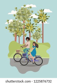 young couple on bicycle in the park