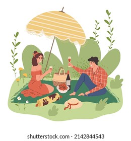 A young couple on a date in the park. A guy and a girl drink wine at a picnic and eat. Romantic dinner in nature.
