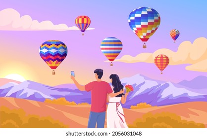 Young couple on a romantic date looking at the flight of balloons