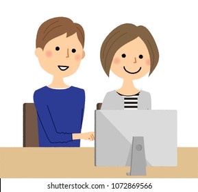 A young couple operating a computer