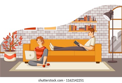 Young couple reading book and using laptop on sofa in the living room
