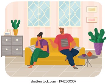 Young couple sitting on couch quarreling at home. Man and woman couple in bad relationship