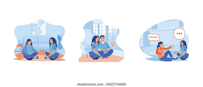 A young couple is sitting on the floor inside the house. Drink tea while chatting together. Two young women are discussing while drinking tea together. 