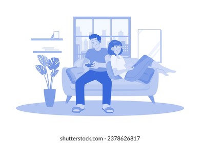 Young Couple Sitting On The Sofa Playing A Game