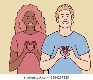 A young couple smiles, forming a heart shape with their hands. They symbolize love, affection, and positive relationships.