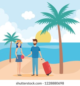 young couple with suitcase on the beach