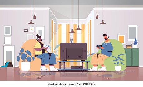 young couple using joysticks playing video games on tv man woman spending time together at home living room interior horizontal full length vector illustration