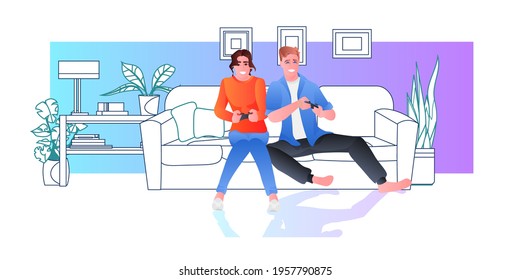 young couple using joysticks playing video games people spending time together at home living room interior