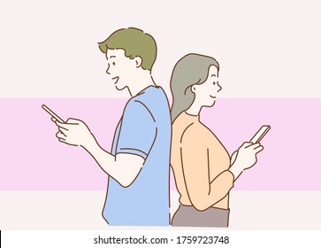 Young couple is using smartphones and smiling while standing back to back. The concept of love. Hand drawn in thin line style, vector illustrations.