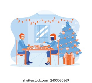 A young couple is wearing Santa hats and sitting together at the dining table. Celebrate Christmas Eve with dinner together at home. Family sharing Christmas Eve concept. 