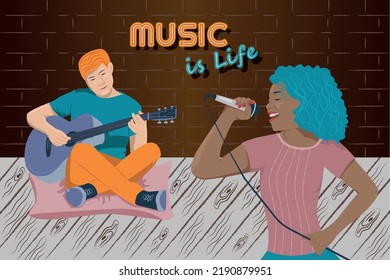 Young Couple Woman And Man Duet Where Man Playing The Guitar And Woman Singing Into The Microphone