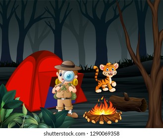 Young cute boy and magnifying glass standing near the red tent