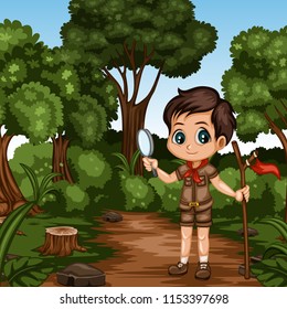 Young Cute Boy Scout Cartoon Character with a Wood Stick and Magnifying Glass  in the Forest. Little Scout Standing on a Forest Path