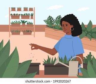 A young cute woman grows plants on the terrace. Trendy eco garden on the porch.