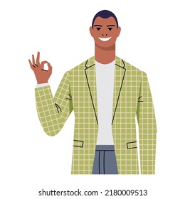 A young dark-skinned man in a suit shows Okay, ok. A gesture of approval. Businessman, leader, office worker isolated on white background. The character smiles and gestures. Flat style. Vector.